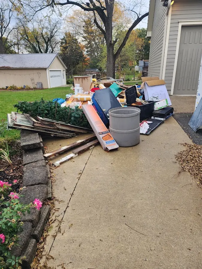 Dumpster being loaded with debris for 12 Yard Dumpster Rental in Salem